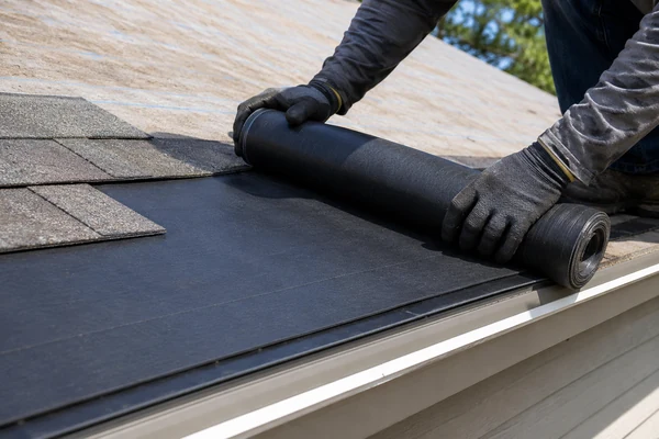 Ice and water barrier installed along a roof eave to stop ice dams