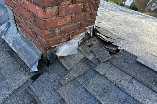 Failed chimney flashing found during a roof inspection in Massachusetts