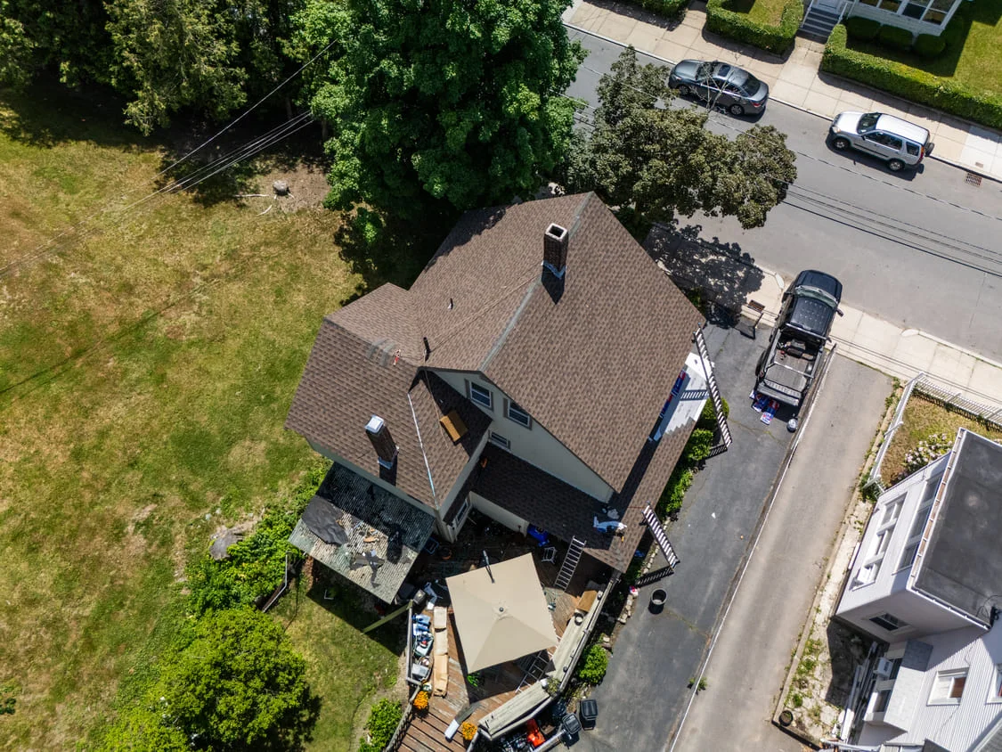Aerial view of a completed architectural shingle roof replacement by Powersol Roofing in Massachusetts