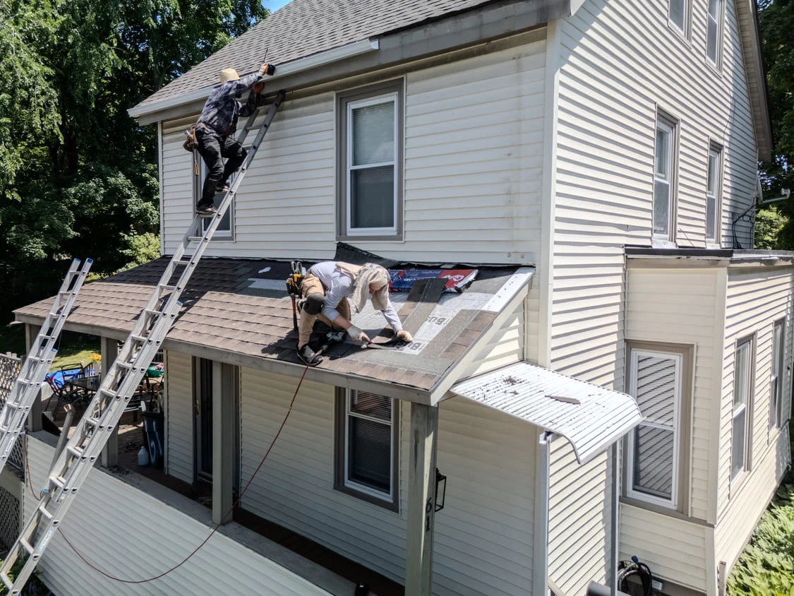 Powersol Roofing crew working on a roof installation in Massachusetts