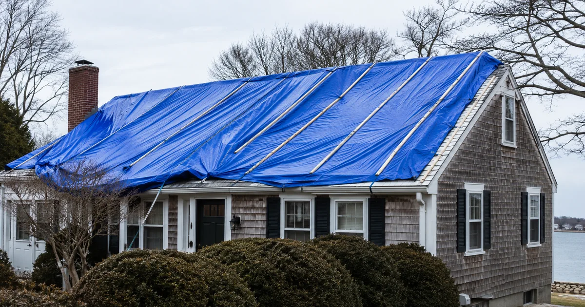 Emergency tarp anchored over an active roof leak in Worcester MA