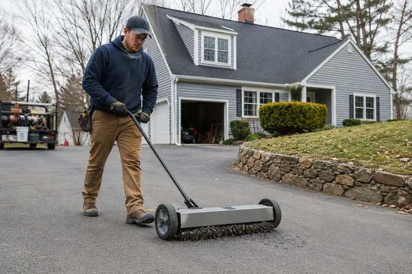 Magnetic nail sweep on driveway after a new roof install