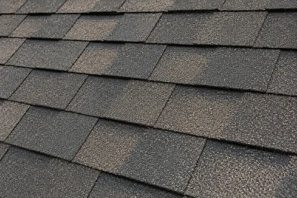 Close-up of correctly nailed asphalt shingle courses