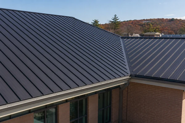 Standing seam metal roof on a pitched commercial building in MA