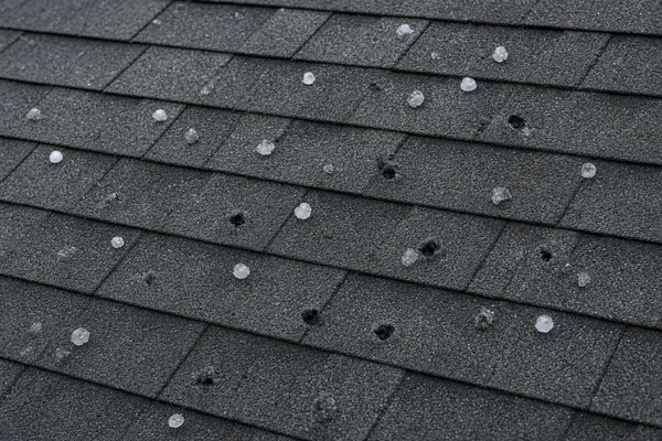 Impact-resistant shingles with subtle hail damage