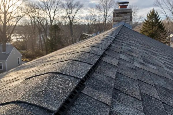 Continuous ridge vent running the peak of a Massachusetts asphalt shingle roof