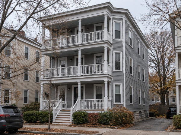Low-slope flat roof on a New England three-decker seen from the street