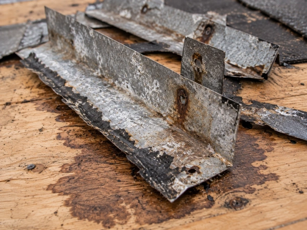 Corroded step flashing and water-stained decking removed from around a skylight curb